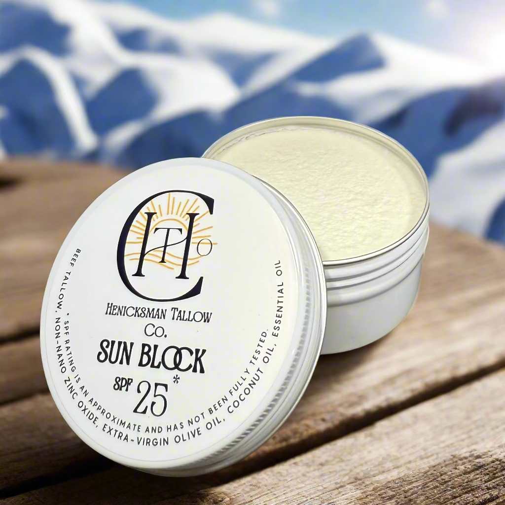 Sun block product with a white lid and black text on a black surface.