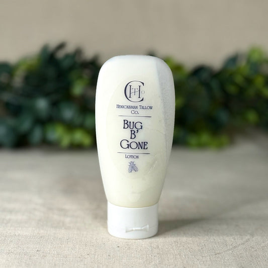 Tube of 'Bug B Gone' lotion on a neutral background with greenery.