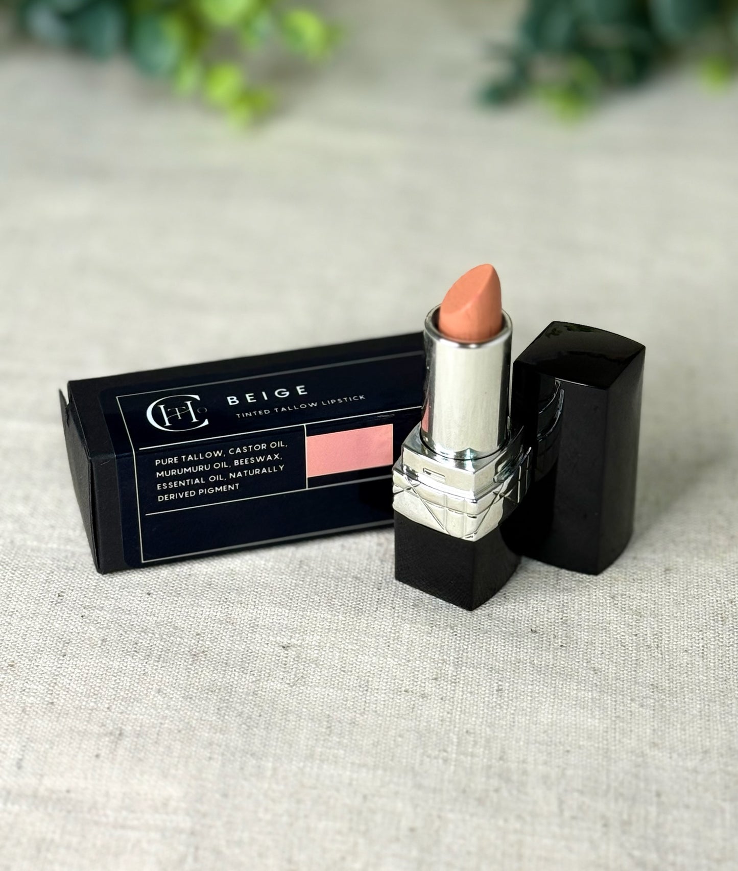 Lipstick with packaging on a textured surface