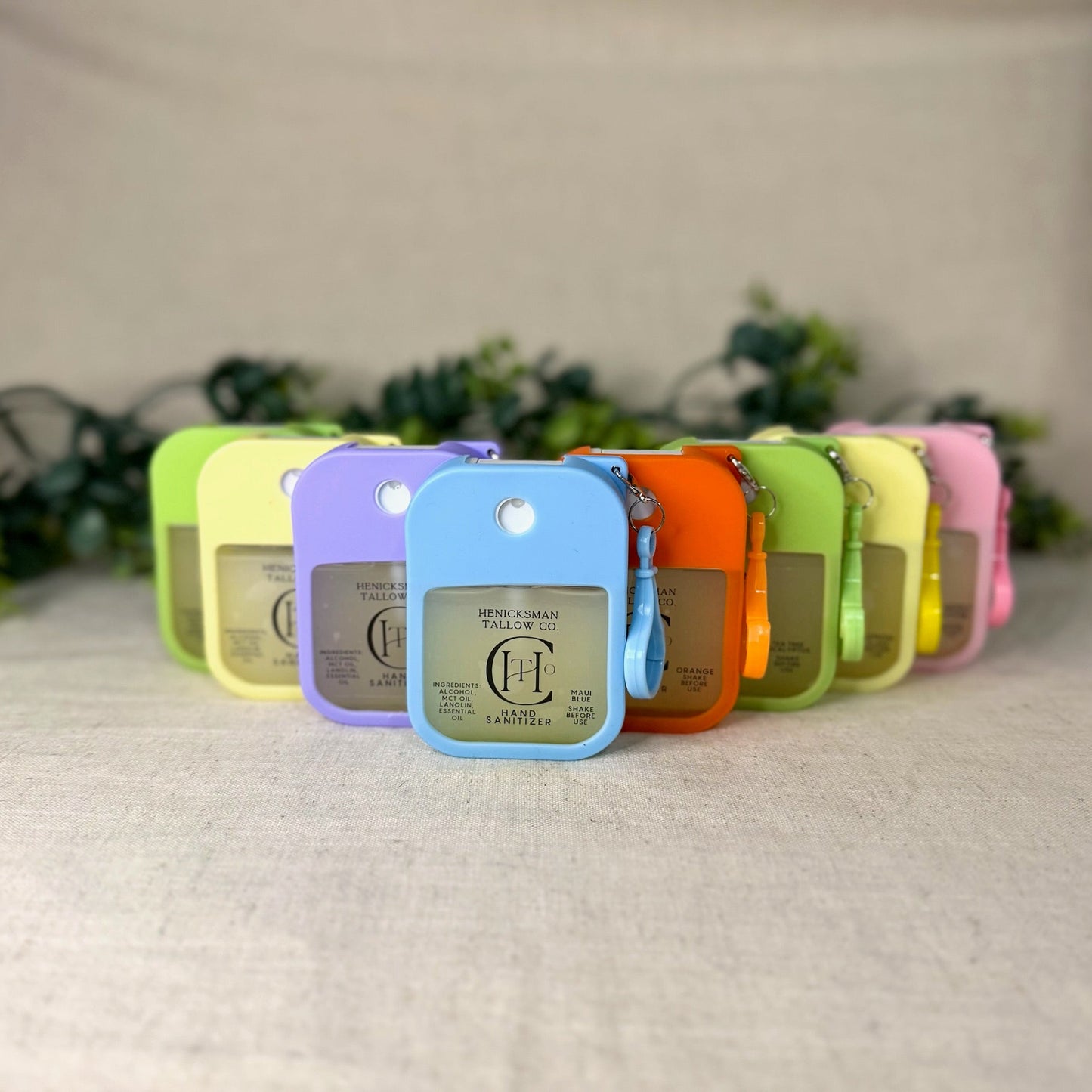 Row of colorful keychains with a brand logo on a textured surface.