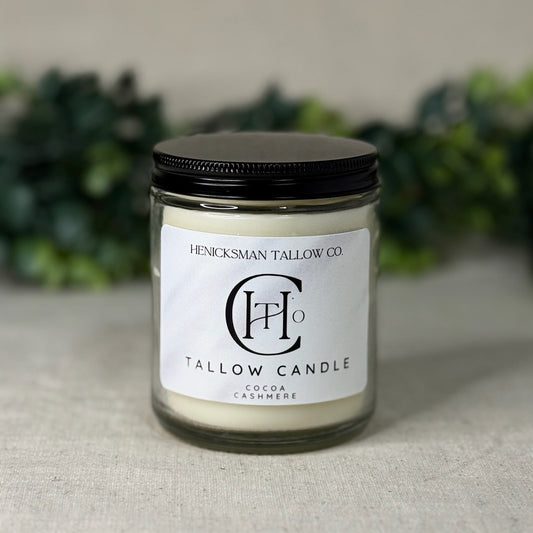 Tallow candle with a black lid on a neutral background