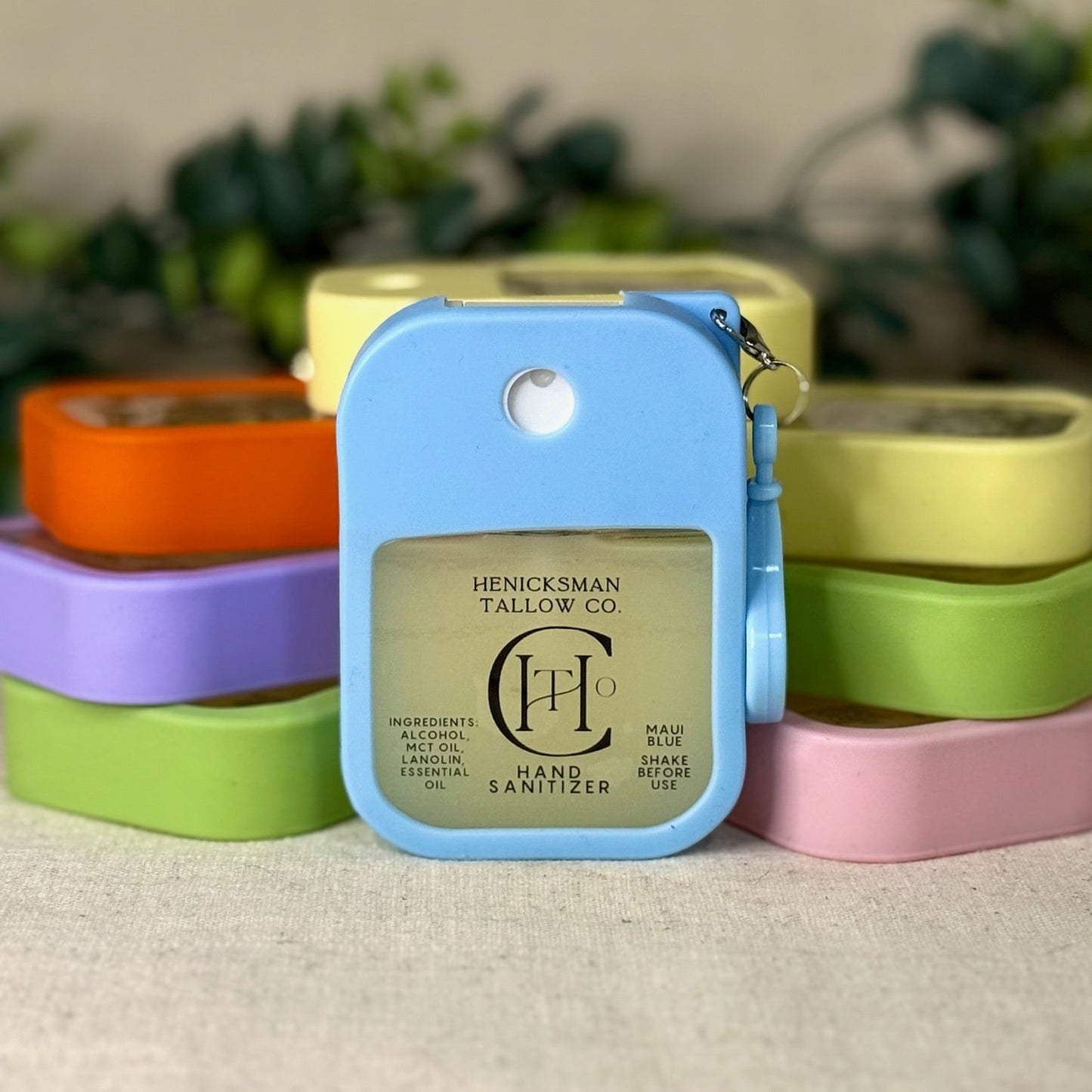 Hand sanitizer with a colorful container in front of stacked containers.